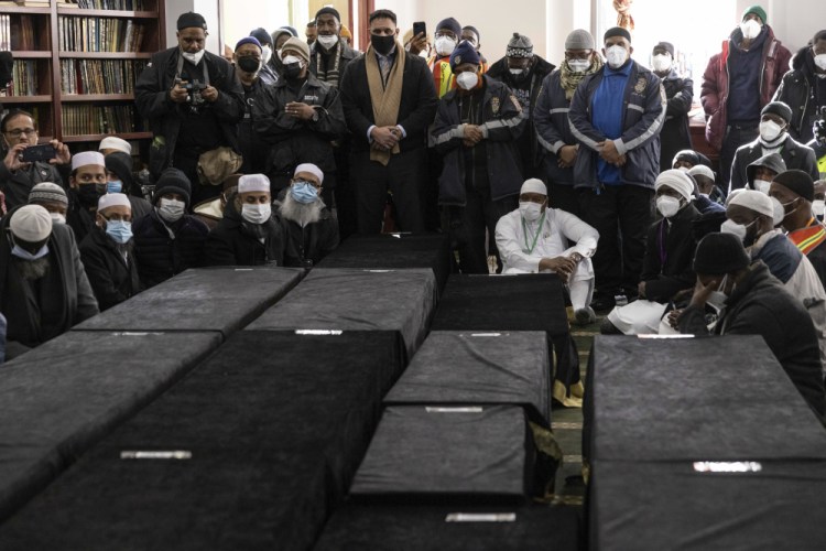 Caskets sit on the floor during a funeral service for victims from a Bronx apartment building which suffered the city's deadliest fire in three decades, at the Islamic Cultural Center for the Bronx on Sunday in New York.