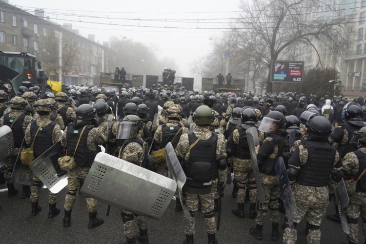 Riot police block a street to prevent demonstrators during a protest in Almaty, Kazakhstan, on Wednesday. Demonstrators denouncing the doubling of prices for liquefied gas have clashed with police in Kazakhstan's largest city and held protests in about a dozen other cities in the country. 
