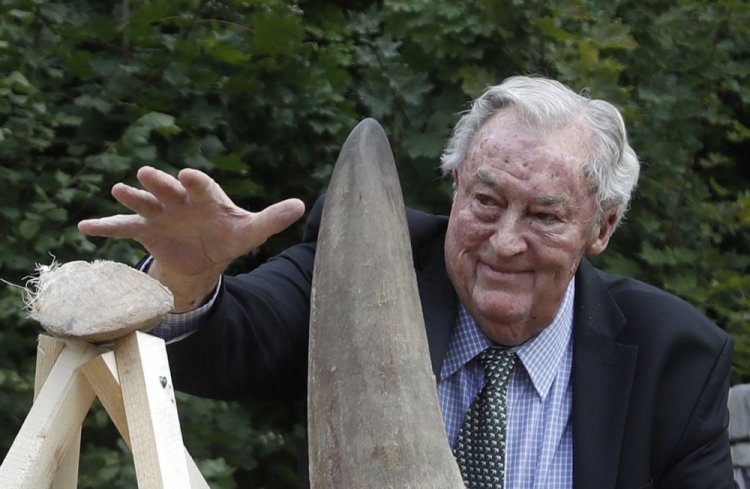 Richard Leakey, Kenyan wildlife conservationist, places a rhino horn to be burned at the zoo in Dvur Kralove, Czech Republic, in 2017. Leakey has died at 77. The cause of death was not announced. 
