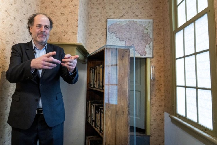 Ronald Leopold, executive director of the Anne Frank House, stands next to the passage to the secret annex during an interview in Amsterdam, Netherlands, on Monday.