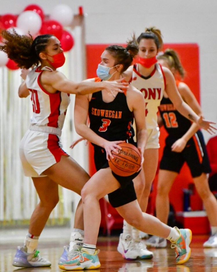 Cony's Indiya Clarke, left, defends Skowhegan's Jaycie Christopher during a girls basketball game Tuesday in Augusta.