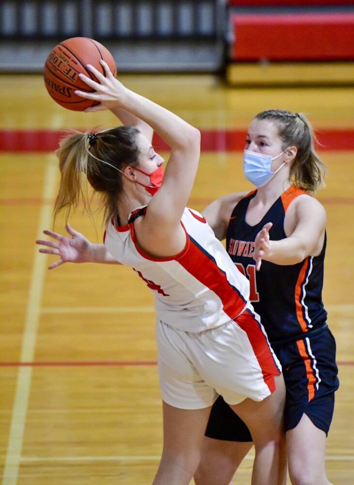 Cony's Alyssa Redman, left, looks to pass around Skowhegan's Callaway LePage during a girls basketball game Tuesday in Augusta.