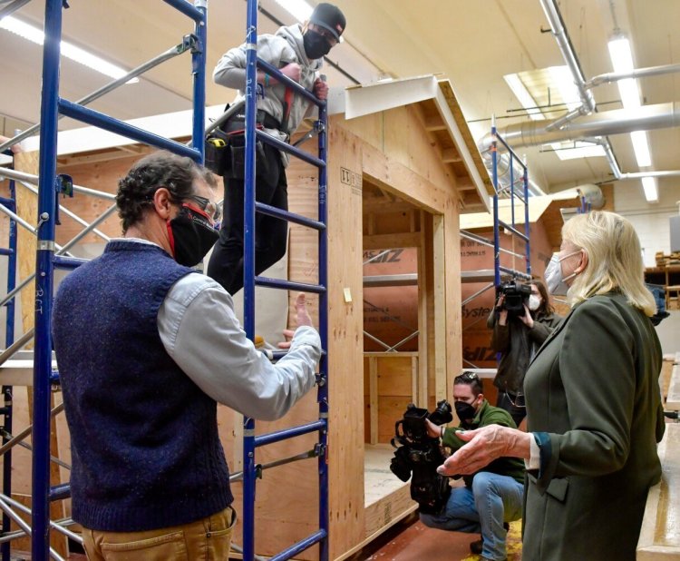 Building construction instructor Curry Caputo, left, and first-year student Sydney Petrie chat Friday with Gov. Janet Mills during her visit to Central Maine Community College in Auburn.