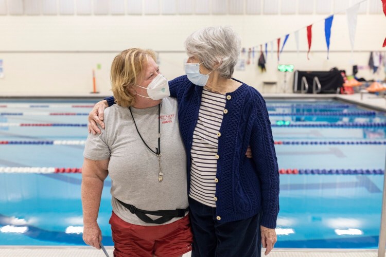 PORTLAND, ME - FEBRUARY 11: Riverton Community Center lifeguard and swim instructor Jeanette Strickland, left, and Marcia Howell, a regular swimmer at the pool, pose for a portrait together on Friday, February 11, 2022. Strickland rescued Howell when she had a heart attack while swimming in December. The firefighter paramedics who arrived on the scene and took over compressions from Strickland also came to the ceremony. (Staff photo by Brianna Soukup/Staff Photographer)