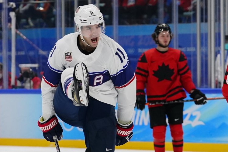 United States' Kenny Agostino celebrates after scoring a goal against Canada during a preliminary round men's hockey game at the 2022 Winter Olympics on Saturday in Beijing. 
