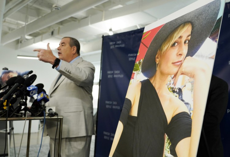 Brian Panish, left, an attorney for the family of late cinematographer Halyna Hutchins, speaks next to a portrait of Hutchins at a news conference on Tuesday in Los Angeles. Hutchins' family is suing Alec Baldwin and the movie producers of "Rust" for wrongful death, the attorneys said Tuesday.