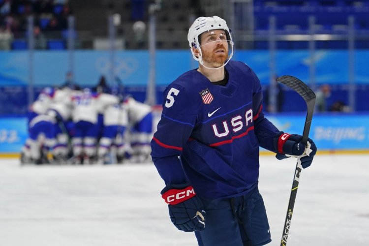 David Warsofsky looks at the scoreboard as Slovakia players celebrate behind him. The United States lost in a shootout. 