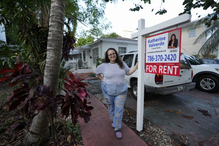 Krystal Guerra, 32, stands outside her apartment, which she has to leave after her new landlord gave her less than a month's notice that her rent would go up by 26%, Saturday, in the Coral Way neighborhood of Miami. 