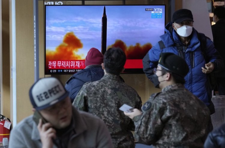 People watch a TV showing a file image of North Korea's missile launch during a news program, at the Seoul Railway Station on Sunday in Seoul, South Korea.
