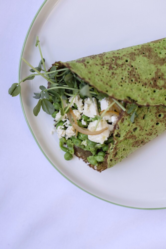 BRUNSWICK, ME - MARCH 3: A spinach and chickpea flour crepe filled with mushy peas, sliced preserved lemons, marinated Bulgarian style feta from Toddy Pond Farm, and pea shoots on Thursday, March 3, 2022. (Staff photo by Brianna Soukup/Staff Photographer)