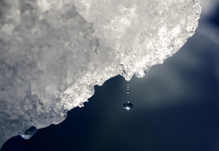 A drop of water falls off an iceberg melting in the Nuup Kangerlua Fjord near Nuuk in southwestern Greenland in August 2017. 