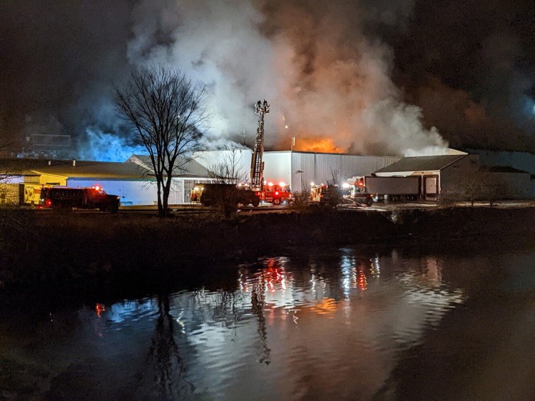Crews battle a fire in a warehouse at Belfast's Penobscot McCrum plant early Thursday morning.