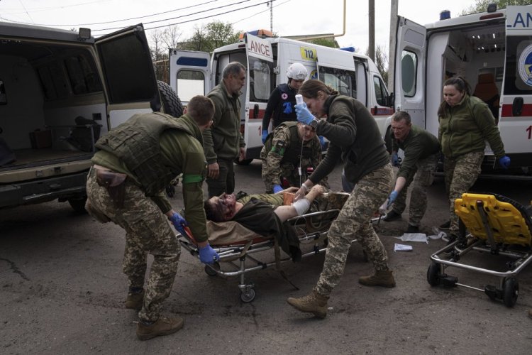 Ukrainian military medics move an injured Ukrainian serviceman to a hospital Saturday in Donetsk region, eastern Ukraine.