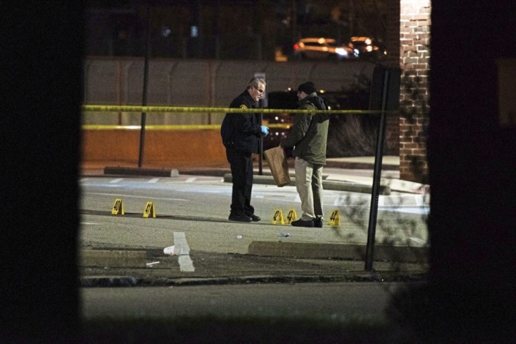 Police gather evidence after a shooting in the North Side of Pittsburgh early Sunday. 