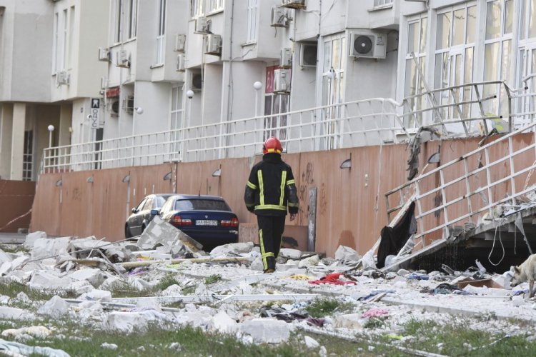A firefighter walks past an apartment building damaged by Russian shelling in Odesa, Ukraine, on Saturday. Ukrainian officials reported that Russia fired at least six cruise missiles at the Black Sea port city.