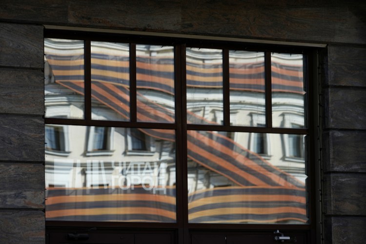 A huge letter Z, which has become a symbol of the Russian military, is reflected in an office building in a street in Moscow on Friday. At first glance, preparations for Monday's celebration of Victory Day, marking the defeat of Nazi Germany in 1945, seem to be the same as ever. But the mood this year is very different. (AP Photo/Alexander Zemlianichenko)