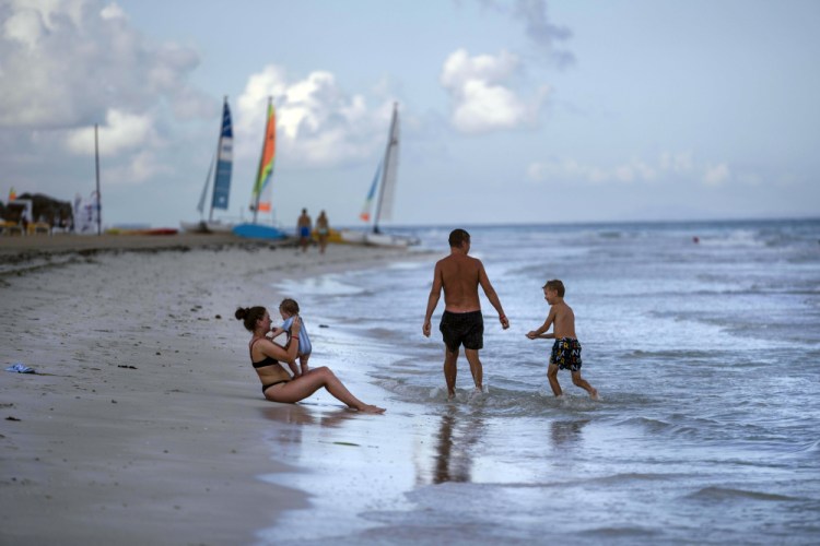 Tourists are seen along the beach at the Iberostar Selection Varadero hotel in Varadero, Cuba, on Sept. 29, 2021. The Biden administration announced Monday that it will allow scheduled and charter flights to locations beyond Havana.