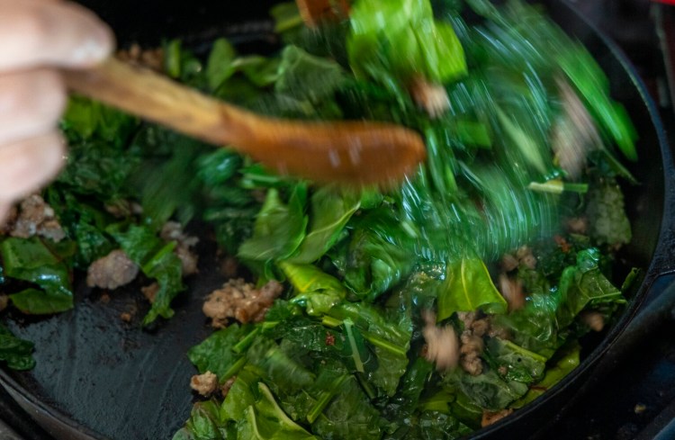 BRUNSWICK, ME - MAY 26: Sauteeing local sausage, kale and swiss chard for pizza topping. (Staff photo by Michele McDonald/Staff photographer)