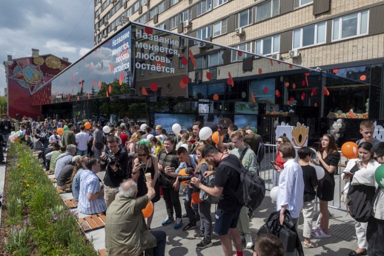 People line up to visit a newly opened fast food restaurant in a former McDonald's outlet in Bolshaya Bronnaya Street in Moscow, Russia, Sunday, June 12, 2022. The sign reads 'The Name Changes, Love Remains'. The first of former McDonald's restaurants is reopened with new branding in Moscow. The corporation sold its branches in Russia to one of its local licensees after Russia sent tens of thousands of troops into Ukraine. (AP Photo/Dmitry Serebryakov)