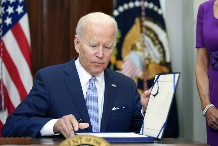 President Biden signs into law S. 2938, the Bipartisan Safer Communities Act gun safety bill, in the Roosevelt Room of the White House in Washington on Saturday.