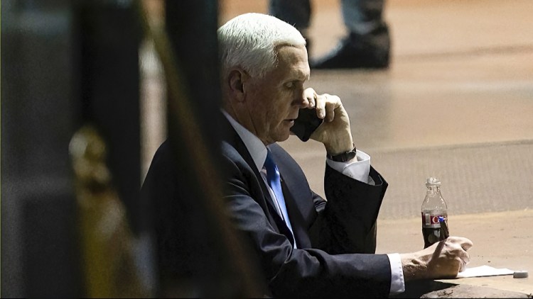 Vice President Mike Pence talks on a phone from his secure evacuation location on Jan. 6, 2021.