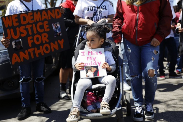 Ailani Alvarez, 2, daughter of Anthony Alvarez who was shot by the police, holds a sign during a protest in Chicago last year. Alvarez was shot several times during a foot pursuit on March 31, 2021.
