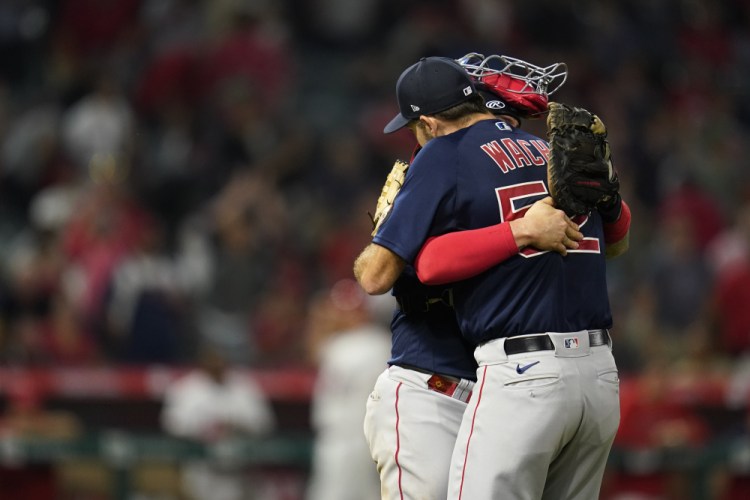 Michael Wacha hugs his catcher after finishing a shutout of the Angels late Tuesday night in Anaheim.