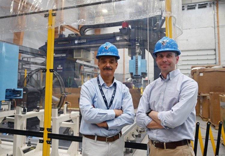 Habib Dagher, left, founding Executive Director and Evan Gilman, Chief Operations Engineer at of the University of Maine's Advanced Structures and Composites Center stand in front of the center's giant 3D printer.
