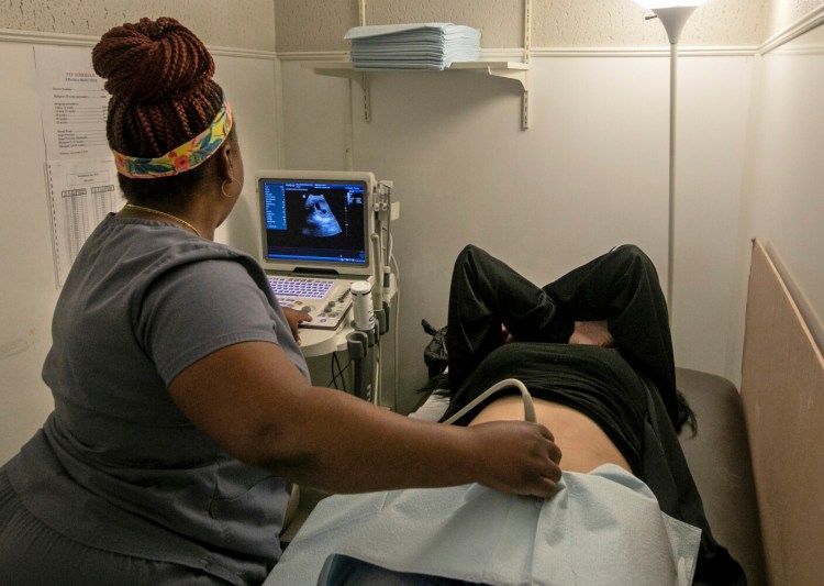An operating room technician performs an ultrasound on a patient at Hope Medical Group for Women in Shreveport, La., on July 6. A survey by Morning Consult found 44 percent of adults were somewhat or very concerned about themselves or a family member losing access to abortion services. 
Yet more than half of them also said it would be hard to take a pay cut or leave their current job in order to move to a less restrictive state.