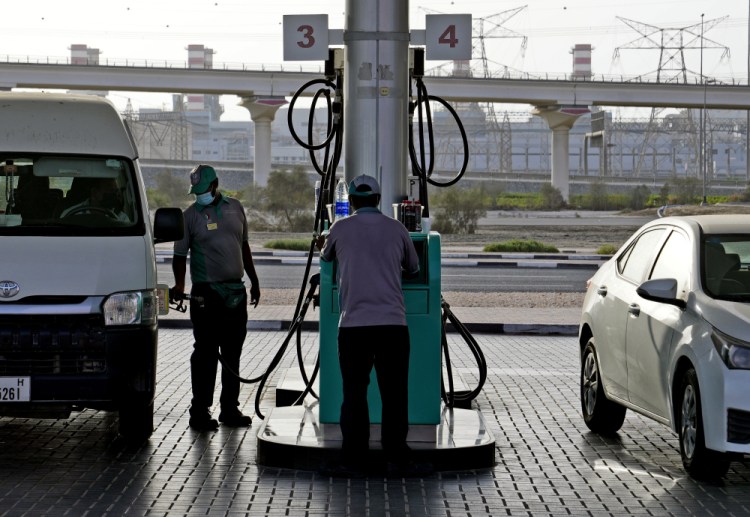 A gas station attendant fills a gas tank on Sunday in Dubai, United Arab Emirates. Though Emiratis are given generous social benefits through the government, inflation has cut into laborers' already meager salaries and some say it isn't enough anymore.