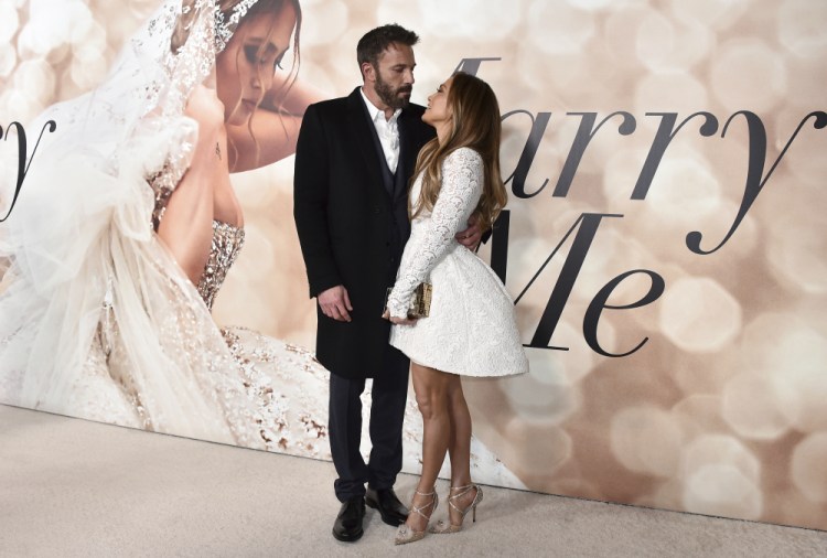 Cast member Jennifer Lopez, right, and Ben Affleck attend a photo call for a special screening of "Marry Me" at DGA Theater on Feb. 8, in Los Angeles. The couple have obtained a marriage license in Nevada, according to court records posted Sunday.