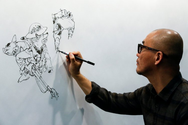 South Korean comic artist Kim Jung Gi draws during the 35th Comic Fair 2017 in Barcelona in 2017. He died Monday in Paris at age 47 after suffering a heart attack. 