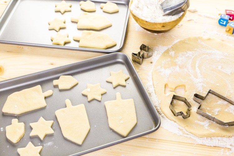 Dreidel and Jewish star-shaped sugar cookies for Hanukkah.