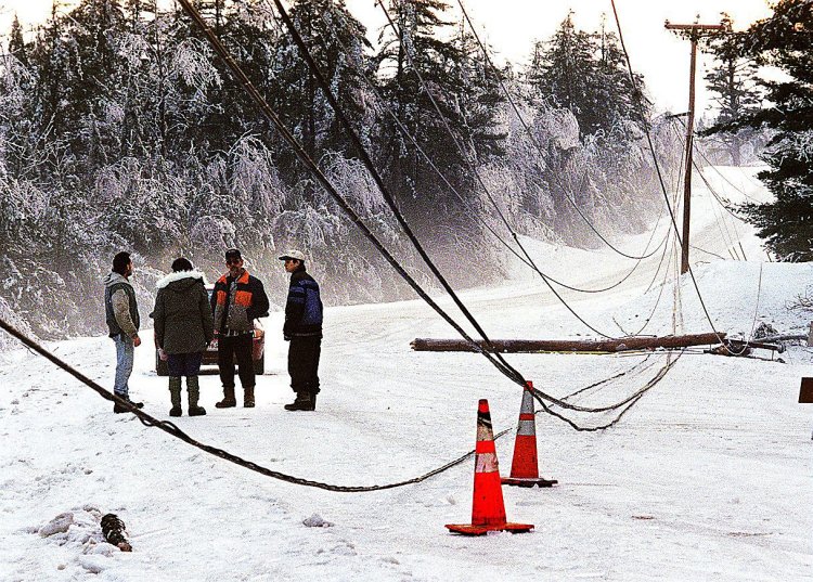 Bystanders look over a section of Albion Road in Waterville closed to traffic on Jan. 11, 1998, due to broken poles and wires in the aftermath of the ice storm. 