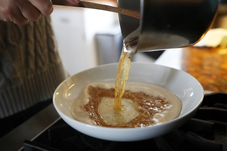Christine Burns Rudalevige pours hot brown butter into a bowl. Don't leave it in the pan you've made it in or it can quickly go from brown to burned. 