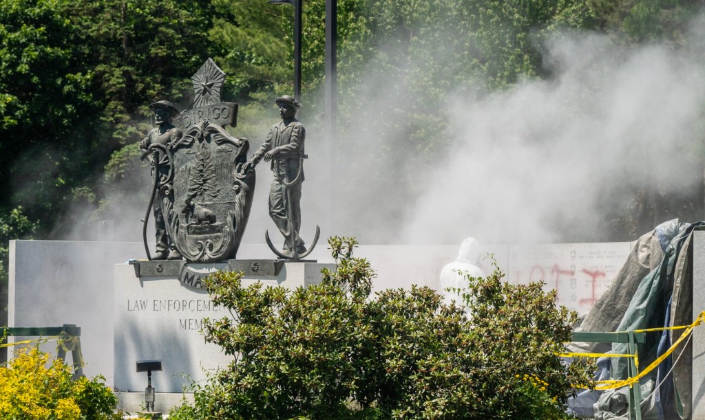 Workers clean up spray paint vandalism of Augusta police memorial