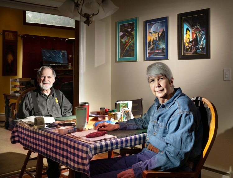 Waterville science fiction authors Steve Miller, left, and Sharon Lee at their dining room table, where they sometimes read each other's contributions to their co-written novels. 