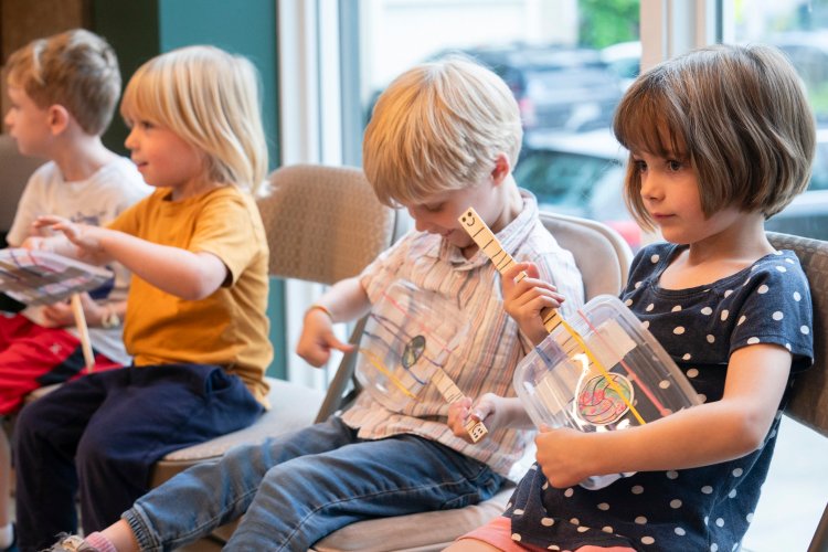 YARMOUTH, ME AUG 18: Little Roots Camp member (R to Left) Claire Bayes, 5 of Falmouth, Milo Bonacci, 4 of Yarmouth,  Bo Witherbee, 4 of Freeport and Miles Taylor, 5 of Falmouth play little homemade guitars during Friday’s  performance in the Fox and the Fiddle Cafe, part of the addition at the 317 Main Community Music Center in Yarmouth. (Photo by Carl D. Walsh/Staff Photographer)