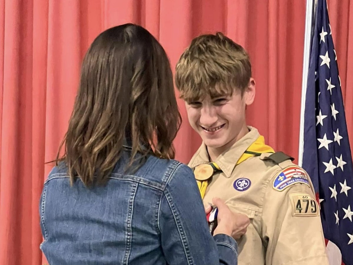 Nathan and Lee: Nathan receives the Eagle Scout Charge from Lee Pettengill who is the Chartered Organization Representative for Troop 479 and served as Master of Ceremonies for the Eagle Court of Honor Ceremony. Nathan: Nathan Choate, Eagle Scout, makes the Scout Sign during his Eagle Scout Ceremony Stephanie pins Nathan: Stephanie Drake Choate pins the Eagle Scout medal onto her son's uniform. "It was so special to have it at Mount Merici Academy. We are so proud of you, Nathan," she said. Joe and Nathan: Joe Doore of the Town of Albion spoke about why Nathan received the Spirit of America Award from the Town of Albion earlier this year. Elijay Parish Lovejoy was born in Albion in 1802 and was an American newspaper editor who was killed by a mob for his firm, published positions denouncing slavery in 1837. Nathan's Eagle Scout Project restored the marker in Albion commemorating Lovejoy.