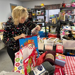 photo of Deb Tanner looking at gifts