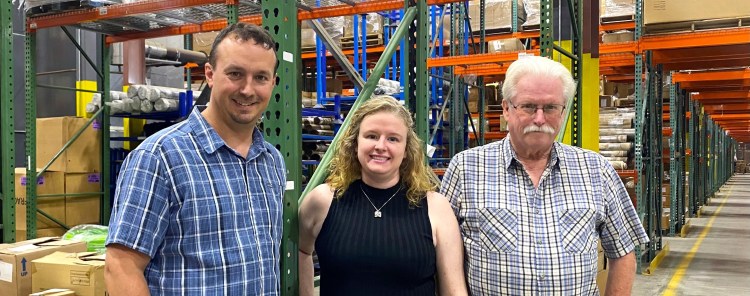 Adam, Faustine and John Reny pose at the Renys Newcastle warehouse. Faustine, John's oldest daughter, and Adam, one of John's nephews, are part of the third generation of owner-operators at the venerable Maine merchandiser.