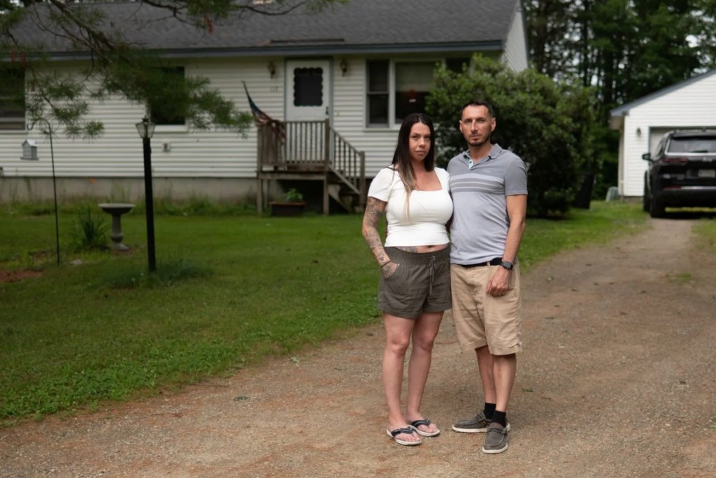 Justin Savage and his girlfriend, Shawna Morse, stand in the driveway of their Limerick home where Maine State Police troopers arrested them in March 2024. (Photo by Garrick Hoffman)