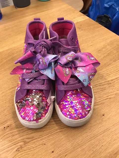 The pink, sparkly sneakers.